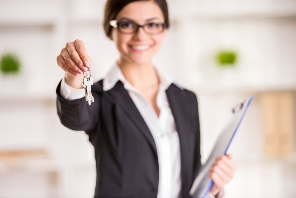 woman holding keys to a house