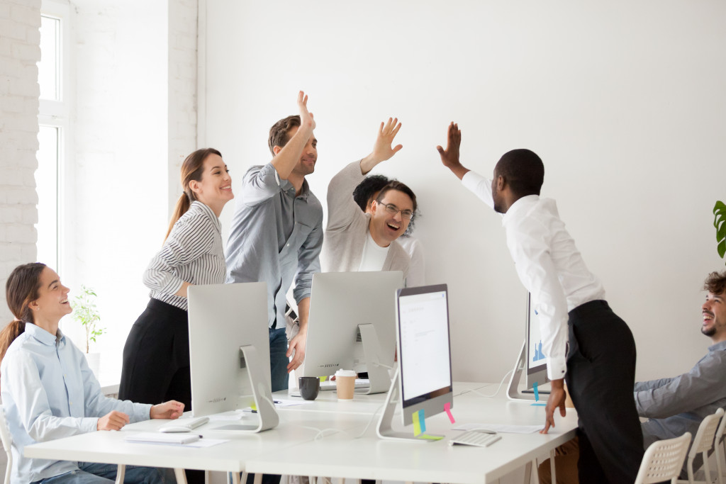 happy employees celebrating in an open office concept